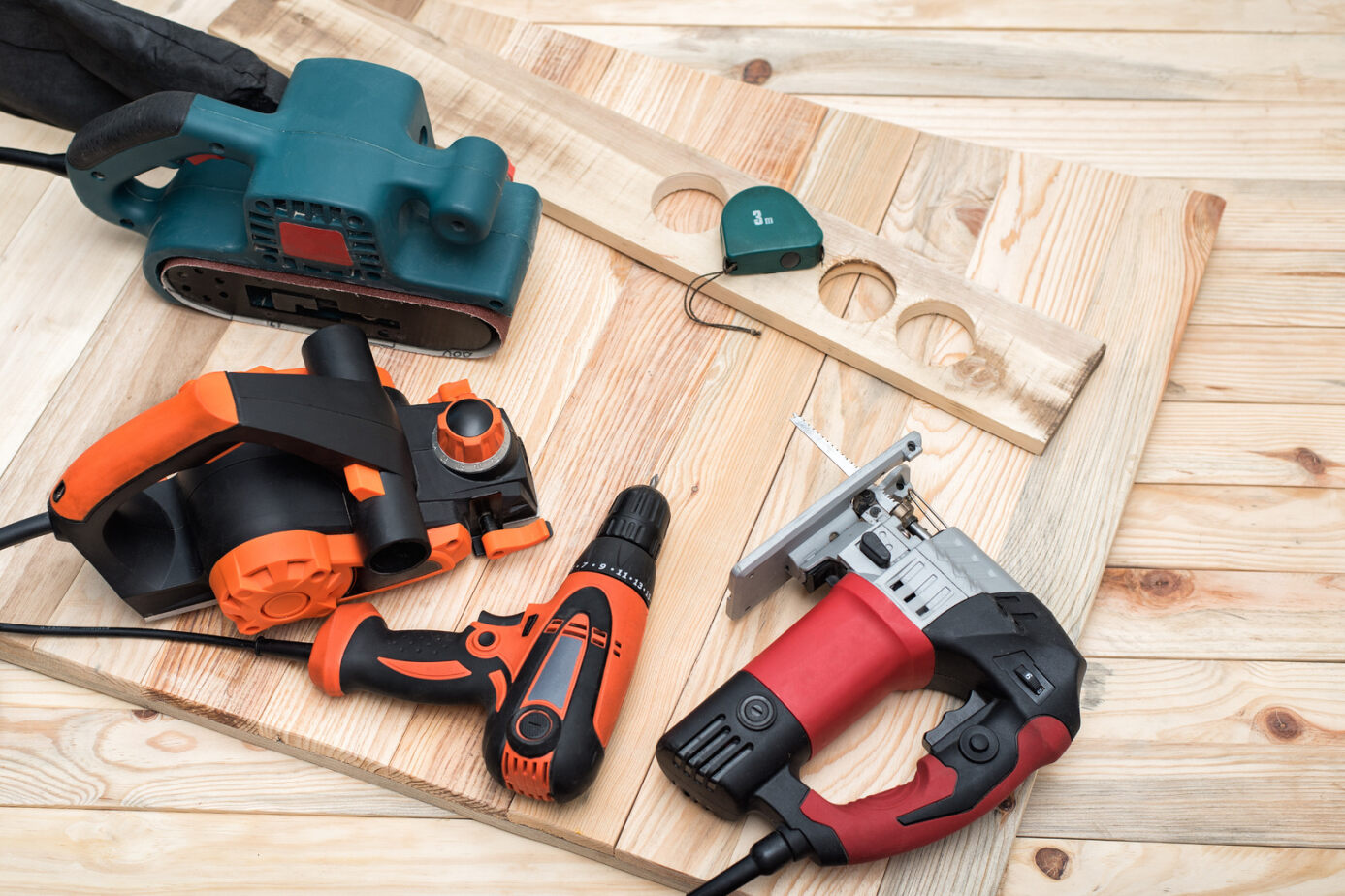 Woodworking power tools arranged on a workshop bench